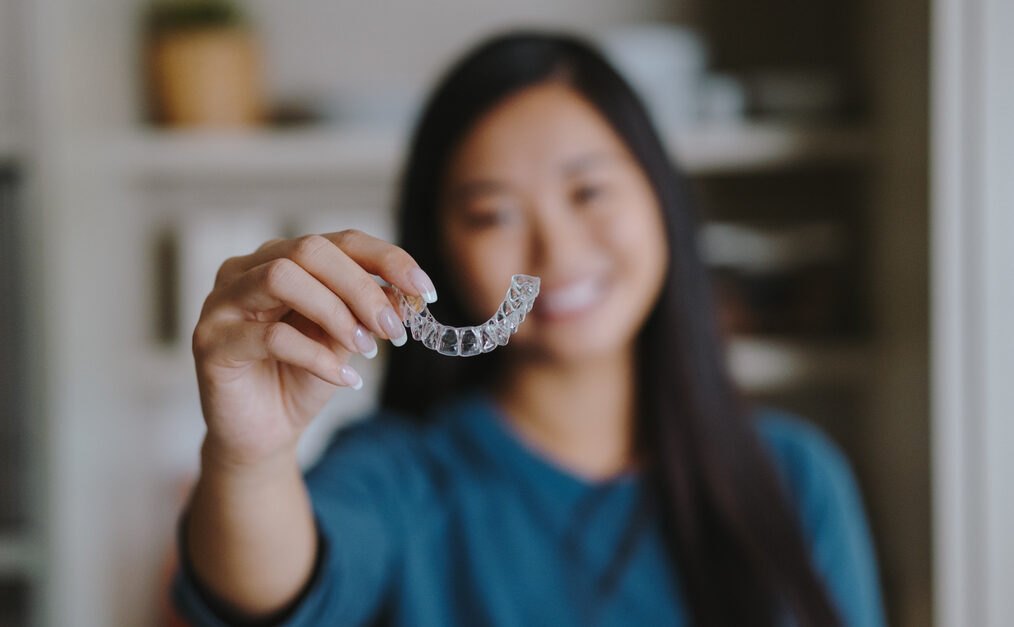 Young woman holding Clear Aligners